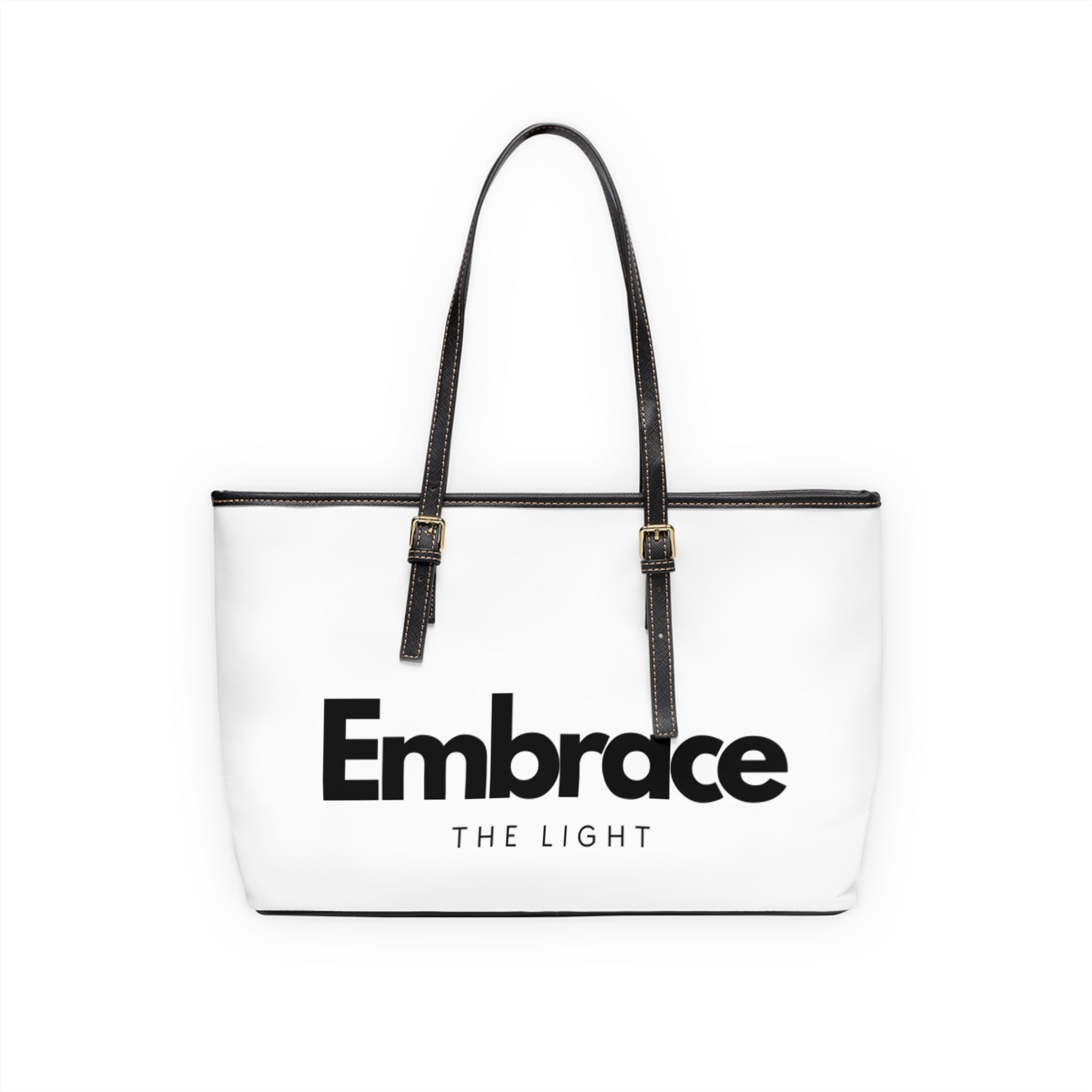 Stylish PU leather shoulder bag with 'Embrace the Light' text design. Spacious, durable, and features black handles with gold accents.