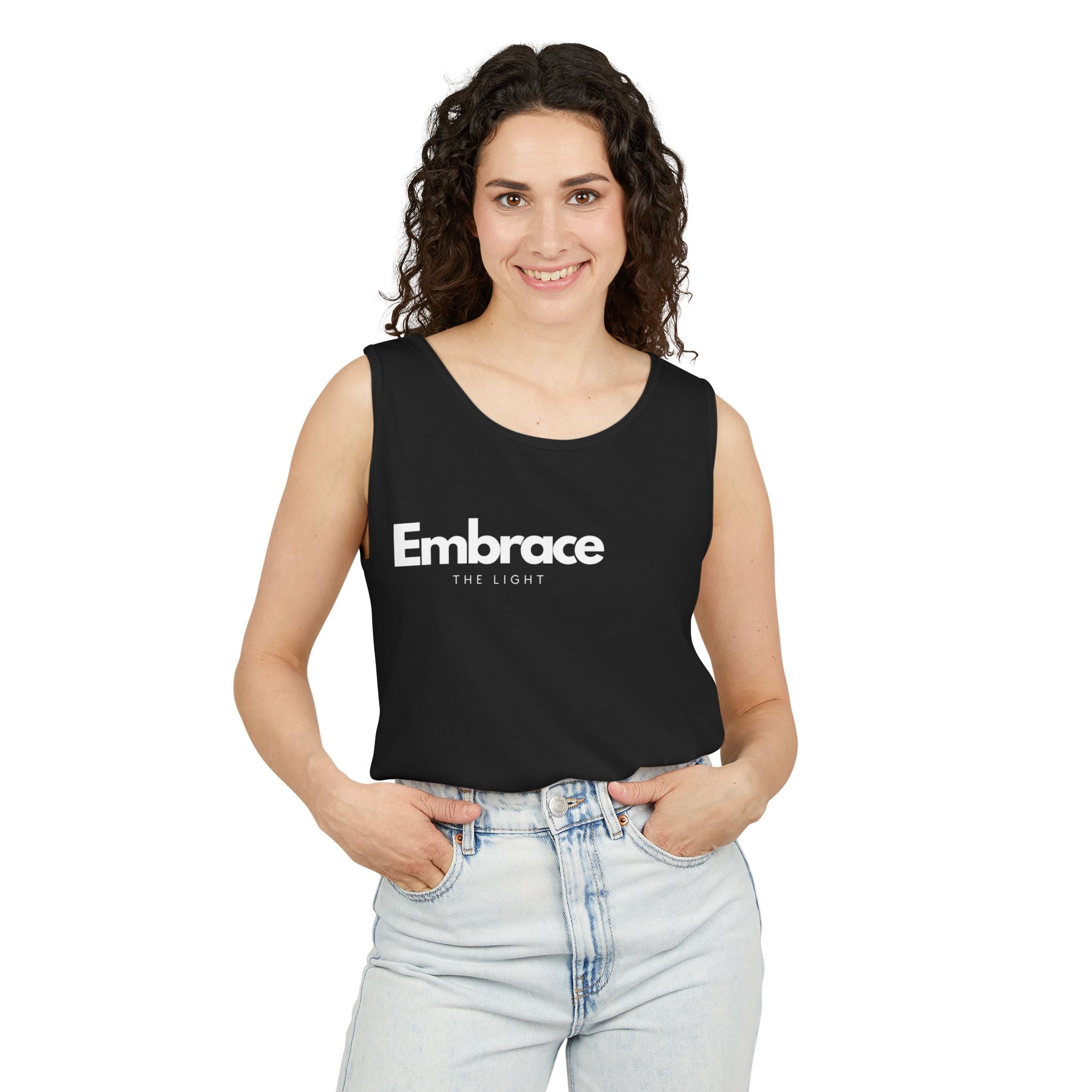 Unisex tank top in black with 'Embrace The Light' text. Made from sustainable US cotton, featuring a relaxed fit and eco-friendly garment-dyed fabric.