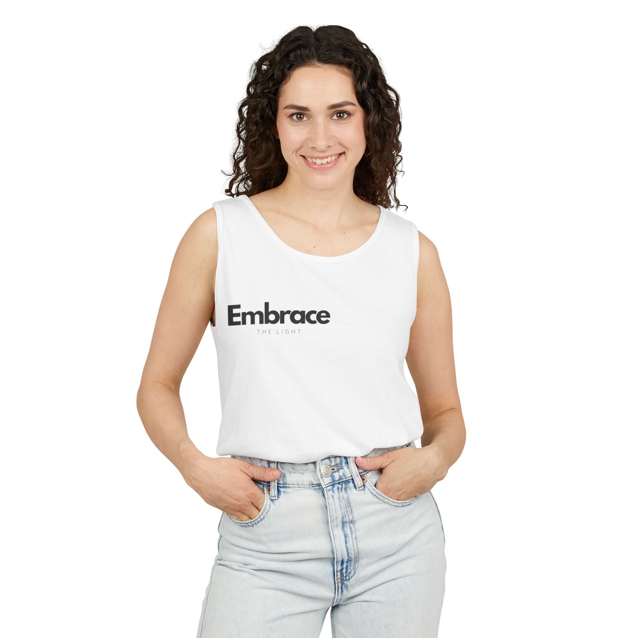 Unisex tank top in sustainable cotton with 'Embrace the Light' text. Relaxed fit, made from 100% US cotton with eco-friendly dyes for vibrant color.