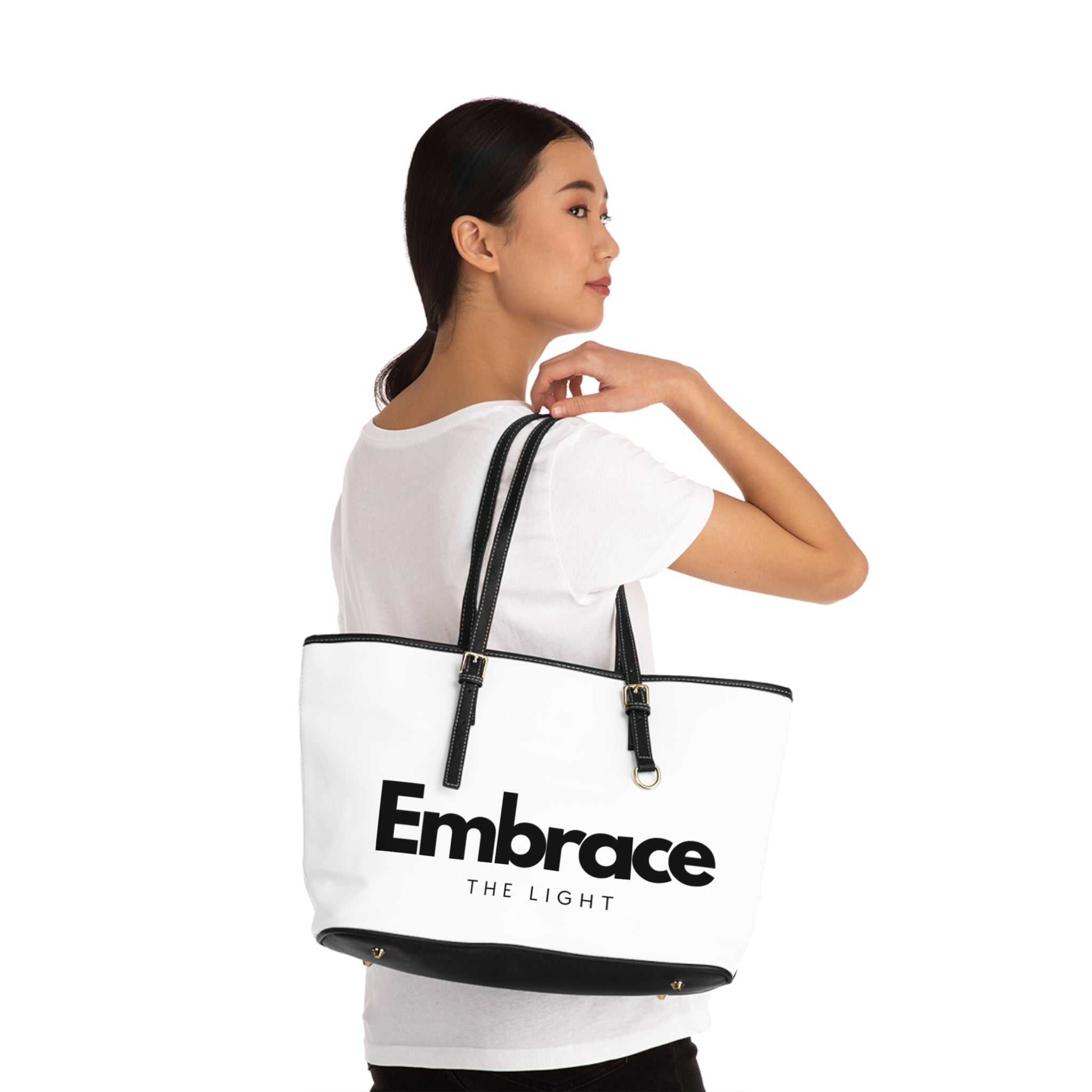 Stylish PU leather shoulder bag with 'Embrace The Light' text design. Spacious and durable with black straps and gold accents, perfect for everyday use.