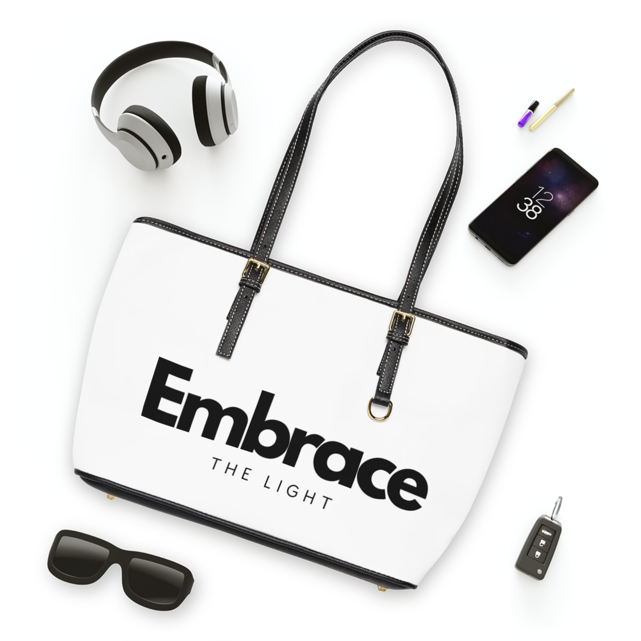 PU leather shoulder bag with 'Embrace the Light' text design, featuring black handles and gold accents. Spacious and durable for everyday use.