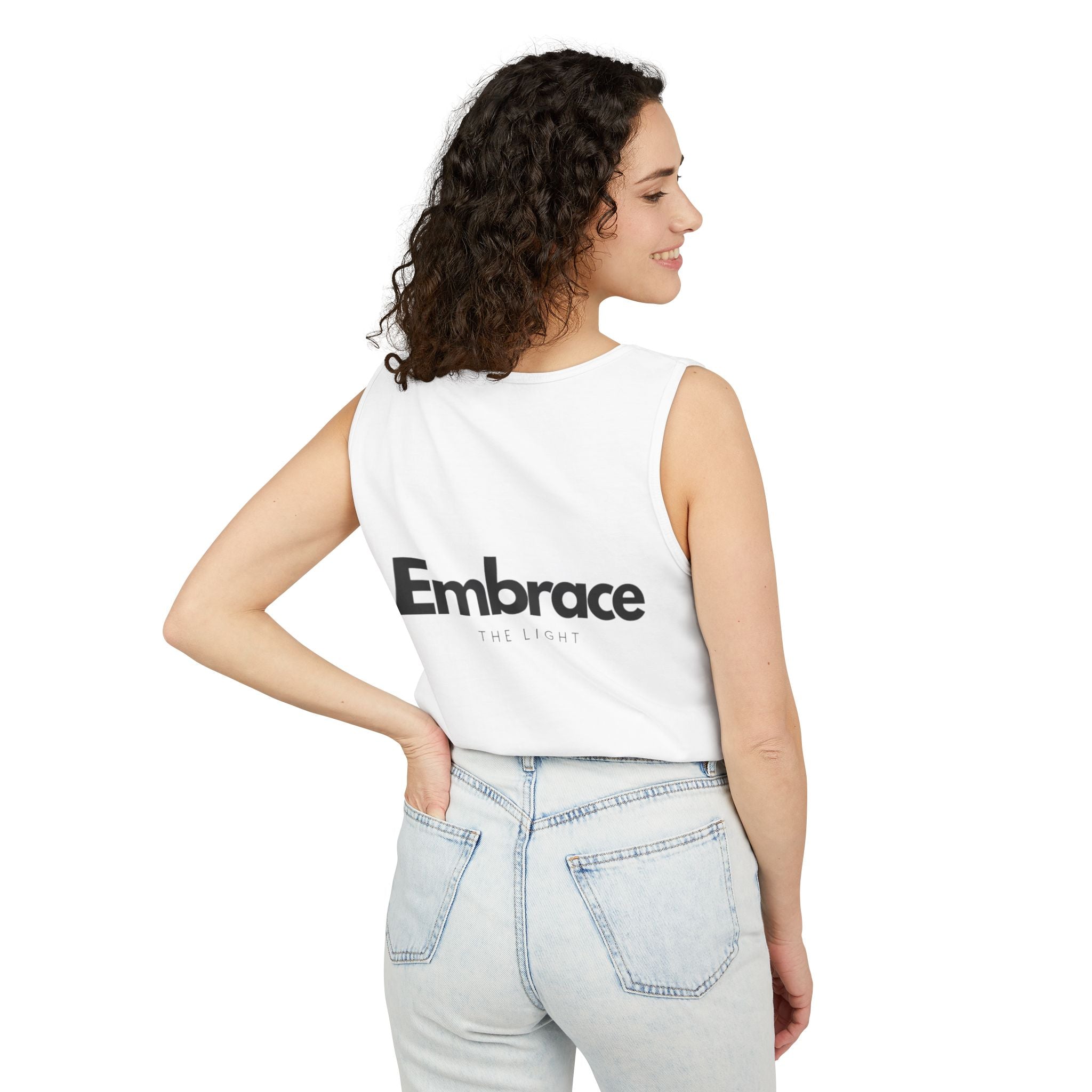 Unisex tank top in sustainable cotton with 'Embrace The Light' text on the back. Relaxed fit, made from 100% US cotton with eco-friendly dyes.